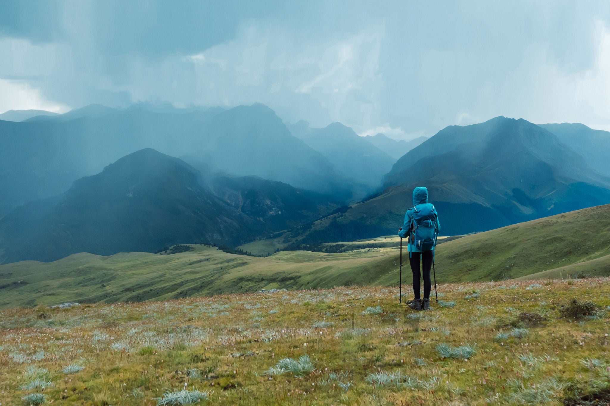 Woman backpacker hiking on high altitude mountain
