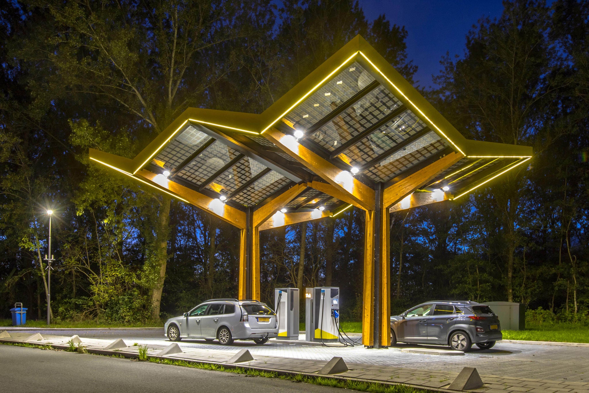 Electric cars charging at electricity filling station in the fast expanding car charging network in the Netherlands