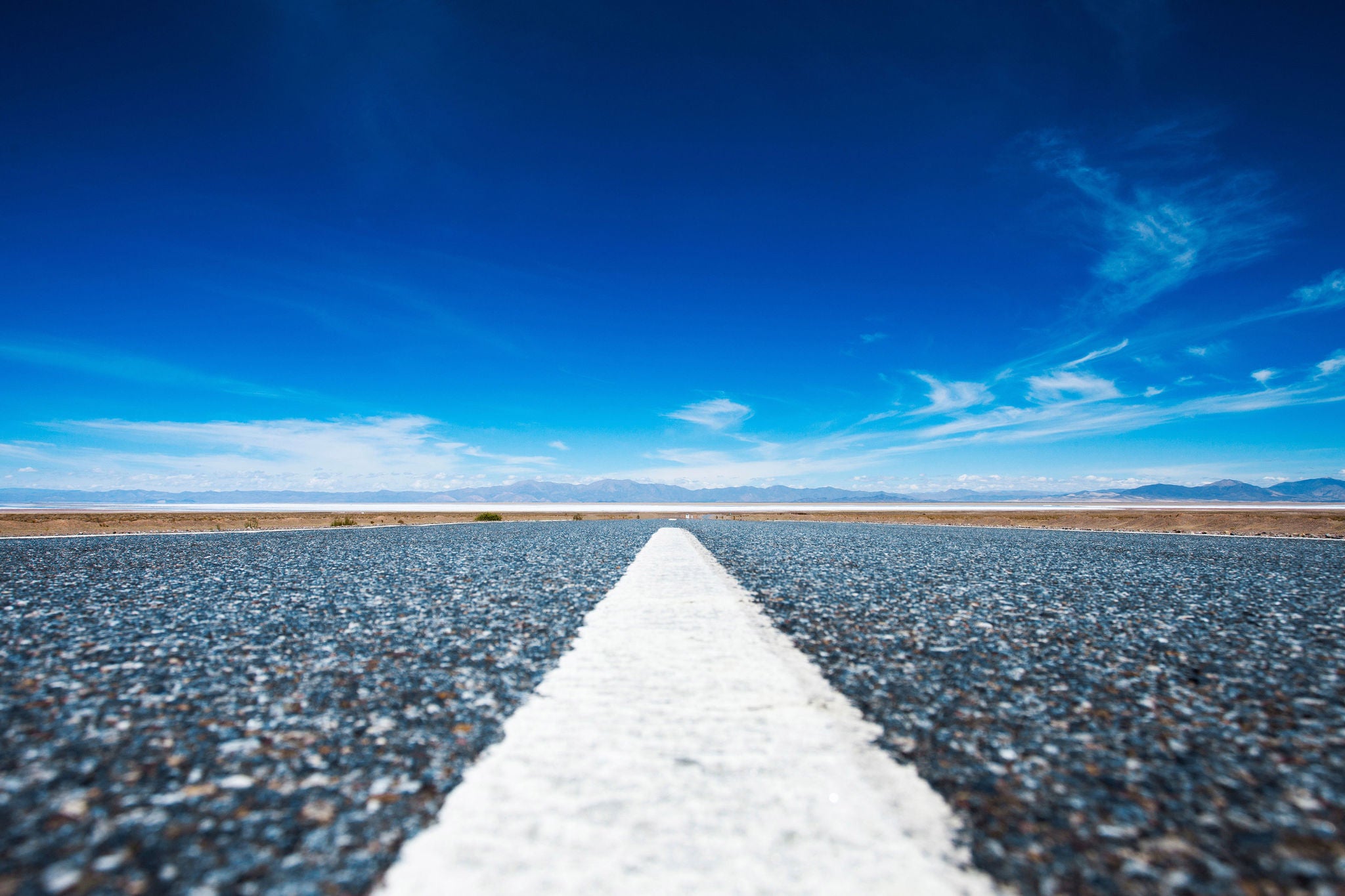 Groundview of asphalt road and azure sky