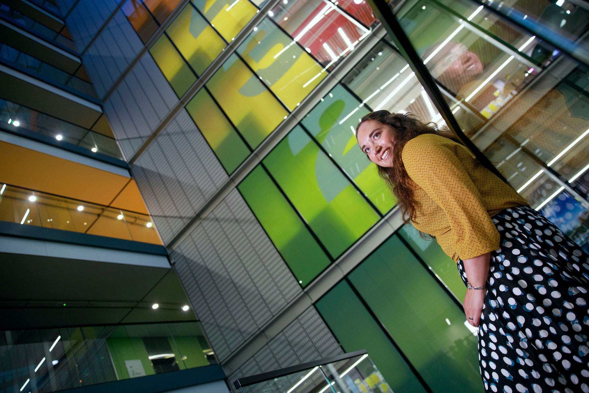Individual standing in a contemporary office atrium