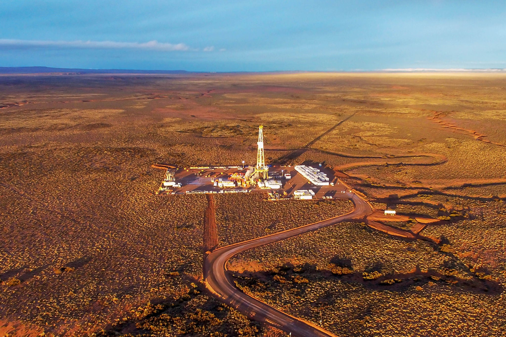 Aerial photo of hydraulic fracturing equipment at sunset. (FRACKING)