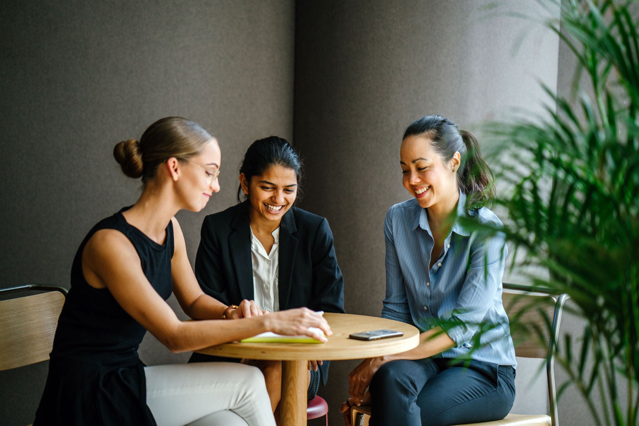 Colleagues having a discussion around a table