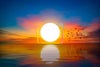 big-sun-at-dawn-on-the-sea-with-beautiful-reflections-and-flocks-of-birds-in-flight