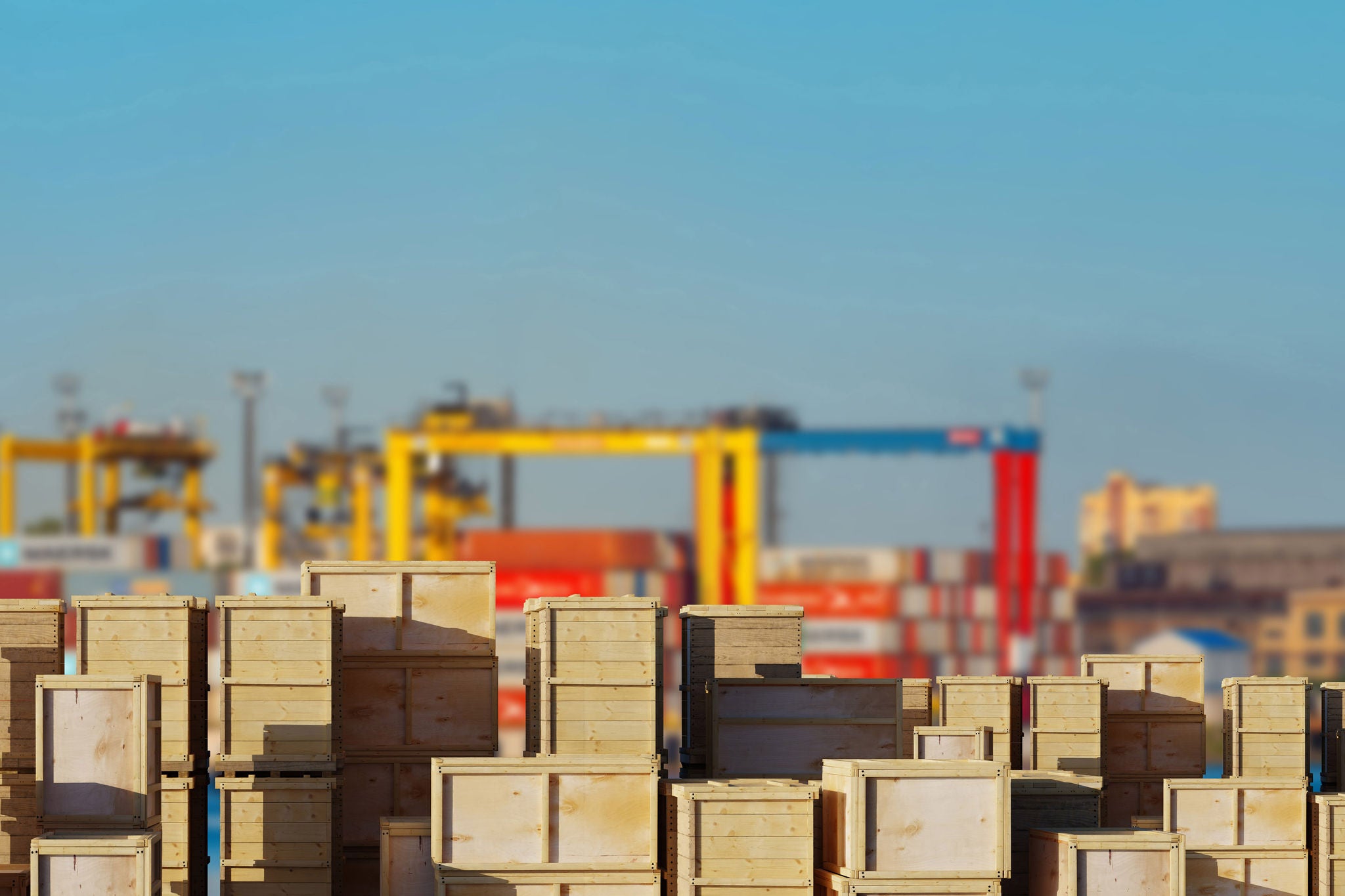 Port logistics stacks wooden cargo crates at a container terminal