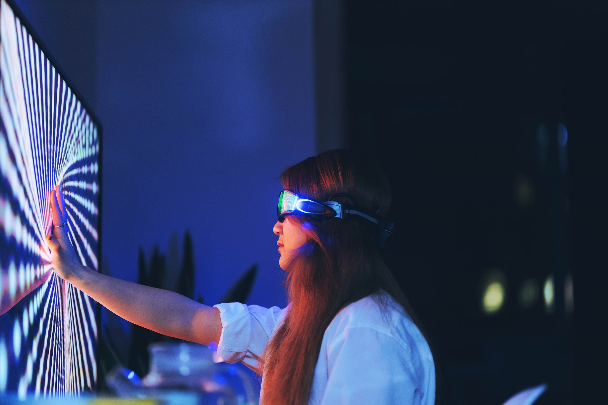 woman wearing augmented reality glasses touching screen