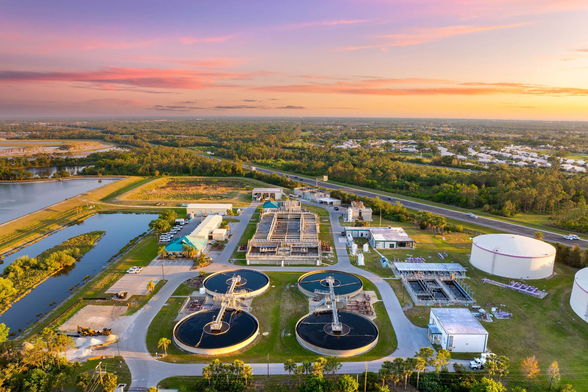 Large-scale industrial water treatment plant purifying and recycling water through filtration and chemical processes to meet health and safety standards.