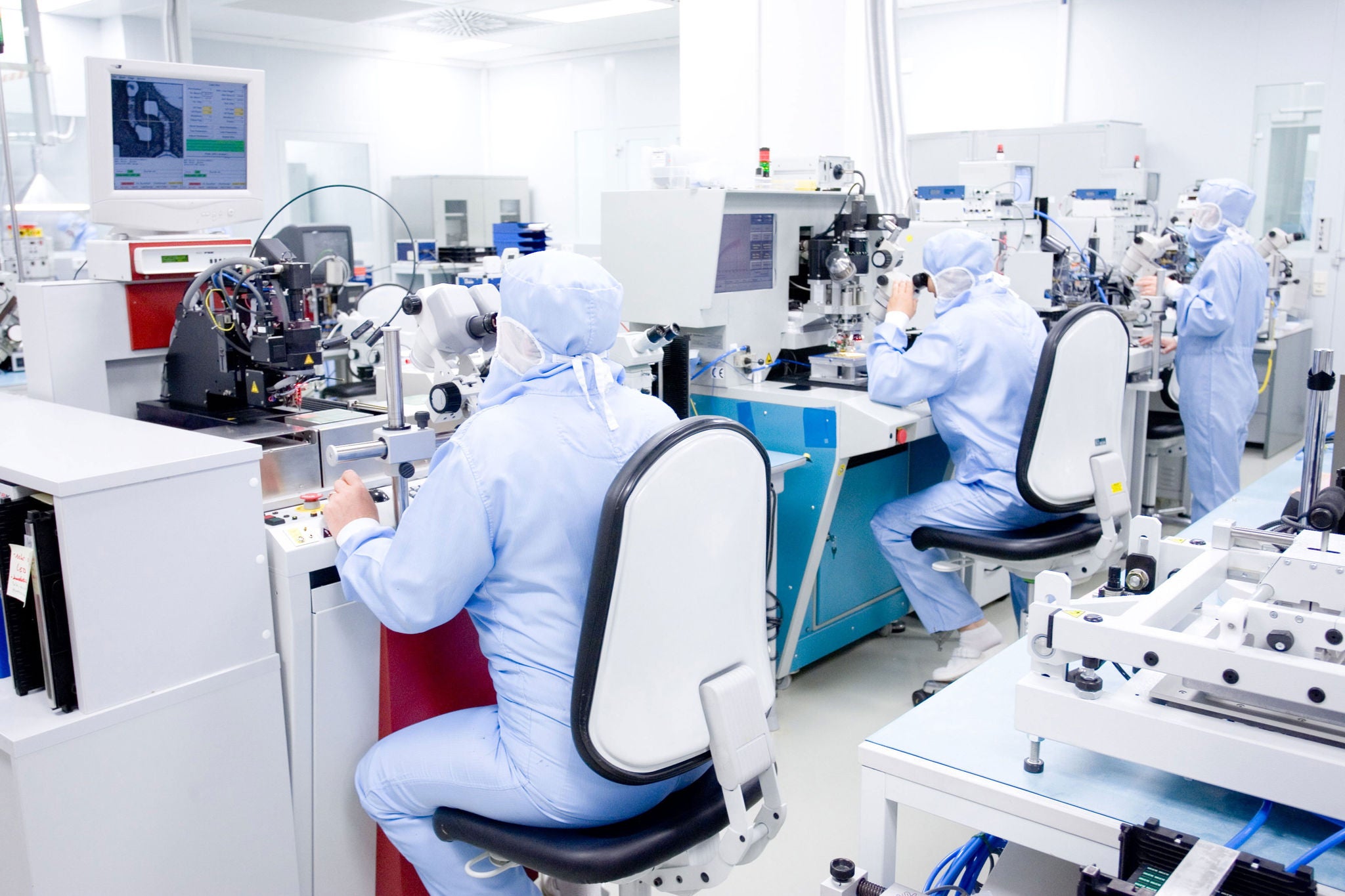  People in a pharma lab working on machines