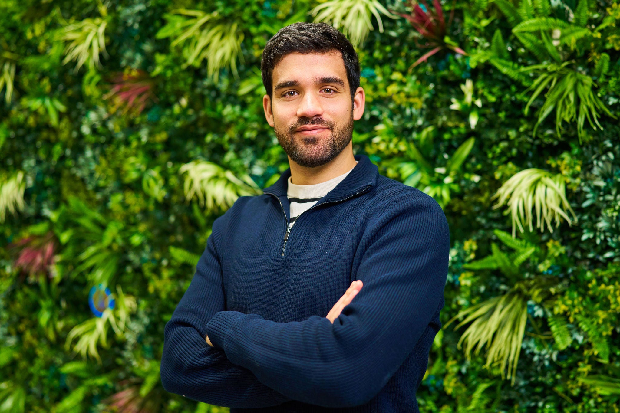 Person in front of a plant wall