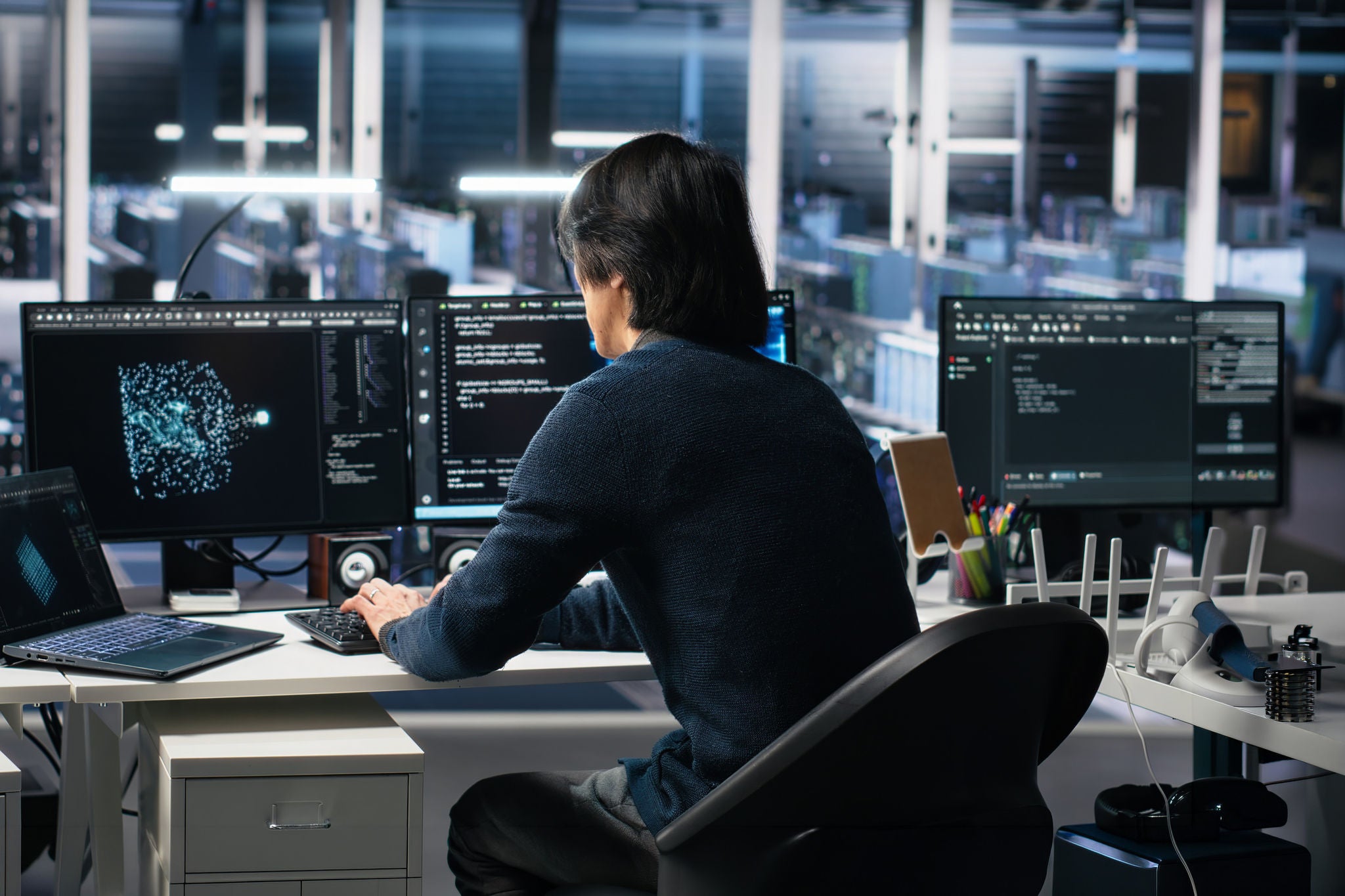 Data center technician entering office, managing AI systems for uptime and efficiency.
