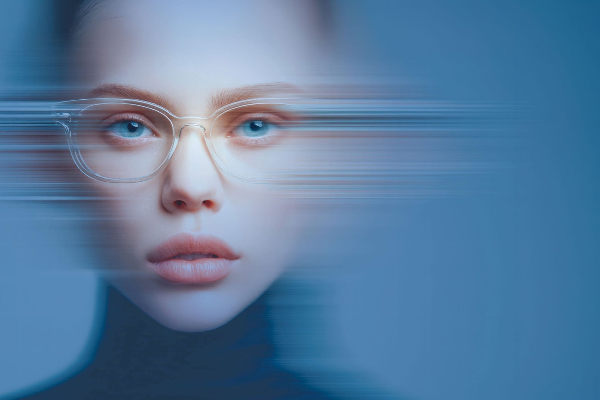 Close-up of a person with clear glasses and blue eyes, sliced by horizontal motion blur on a cool blue background.