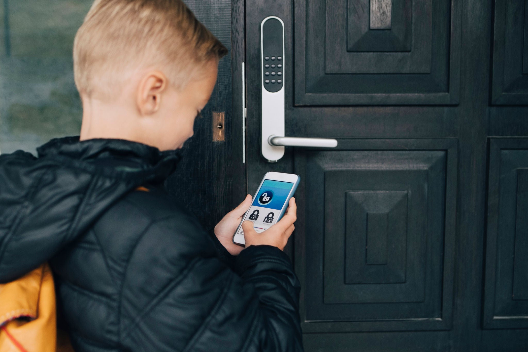 boy using app unlock house door