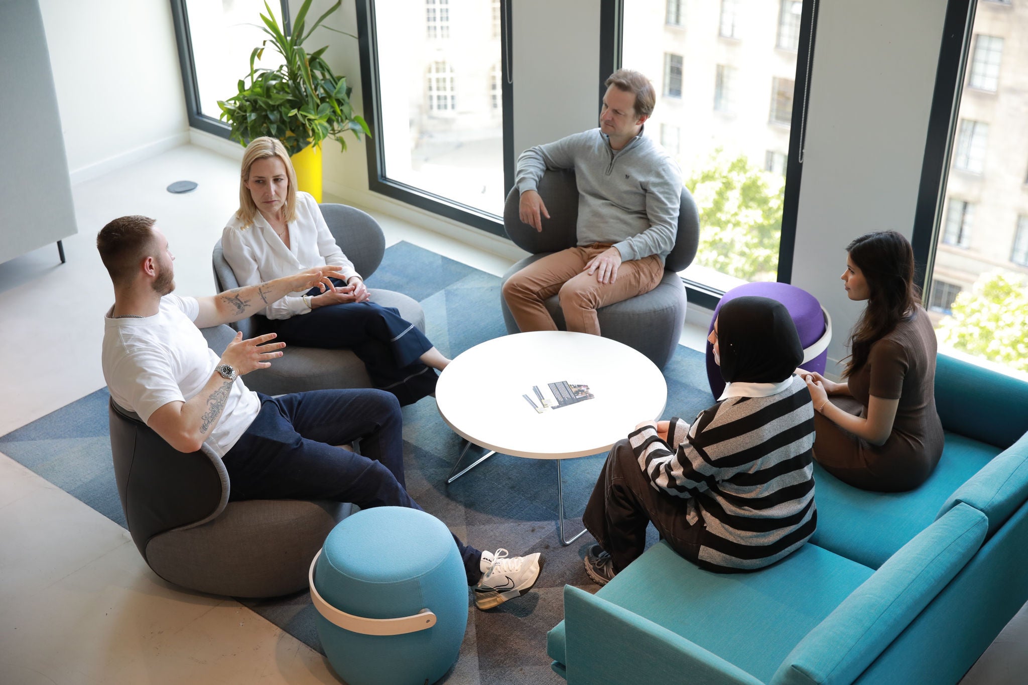 Colleagues engaged in conversation around a meeting table