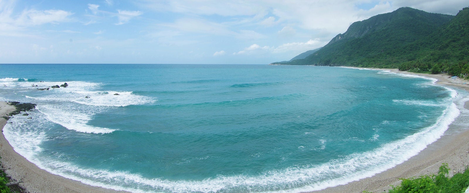 Distorted perspective, oval bay of Caribbean sea at Dominican Republic in summer, cloudy day, fish eye lens