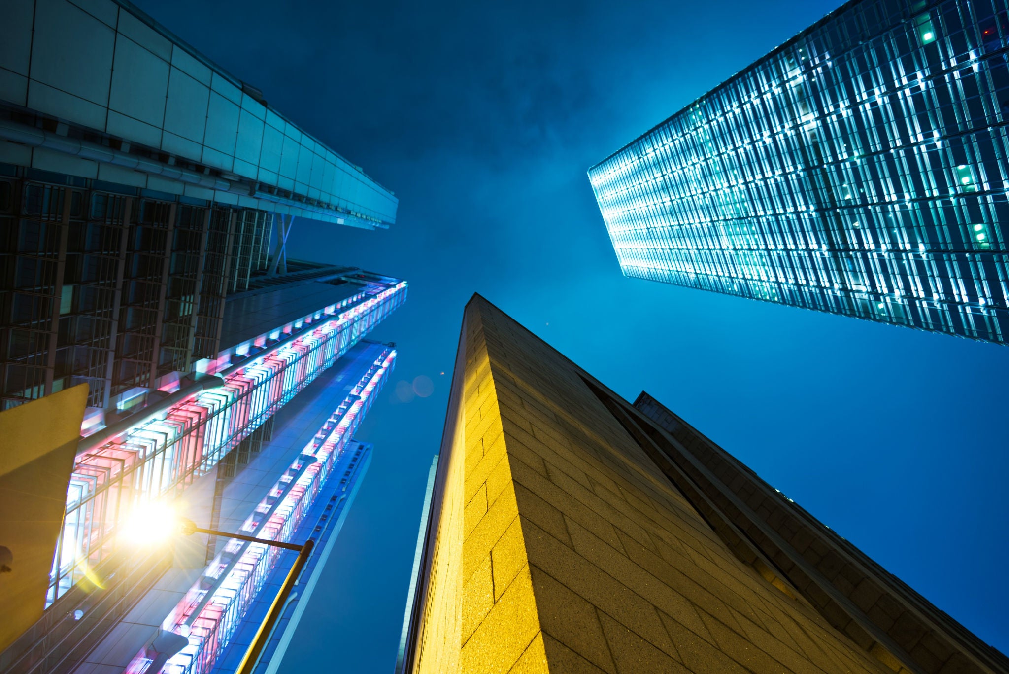 Bottom shot of buildings looking up the sky at night