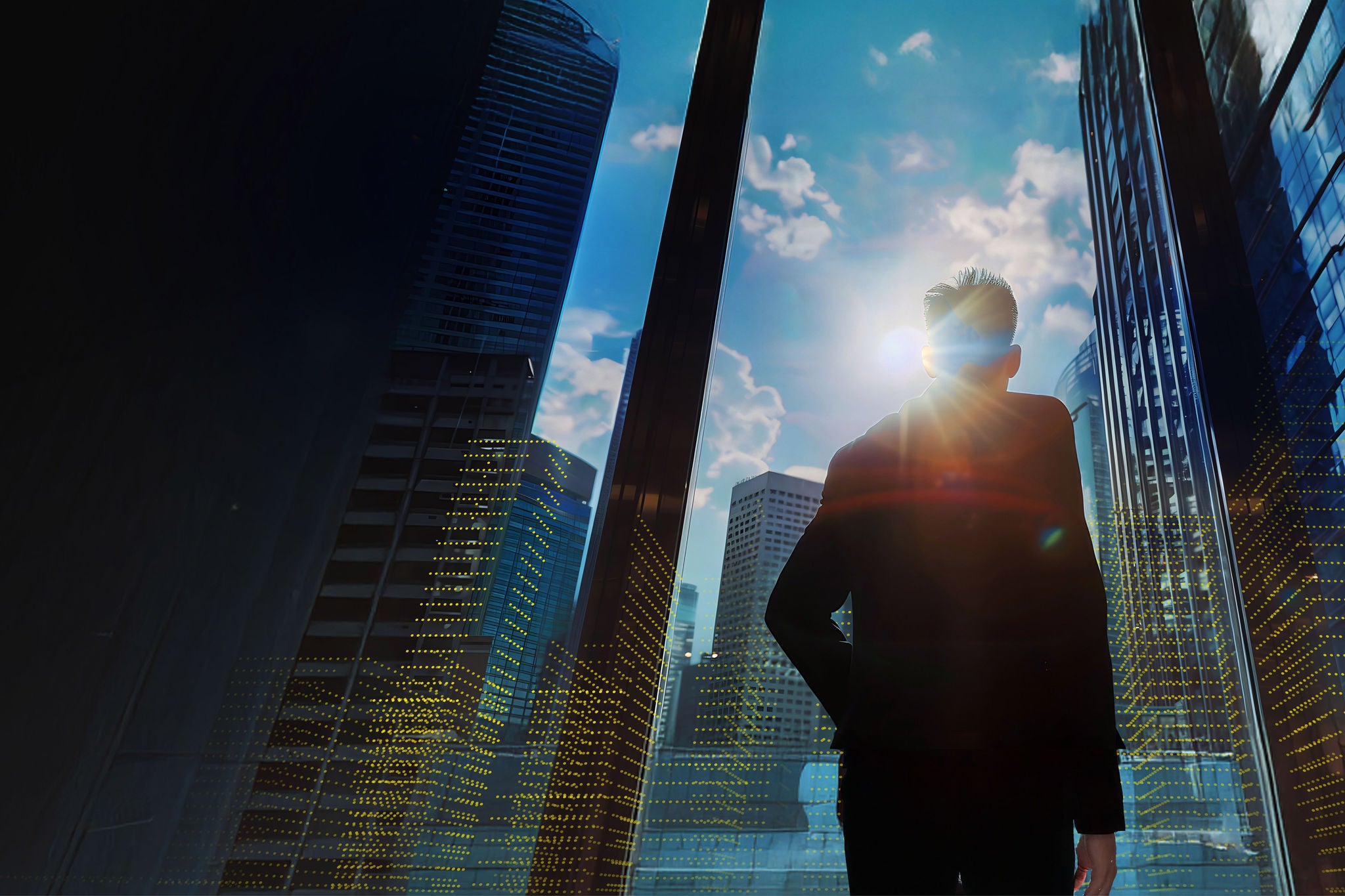 Businessman joy looking up at city skyline from building