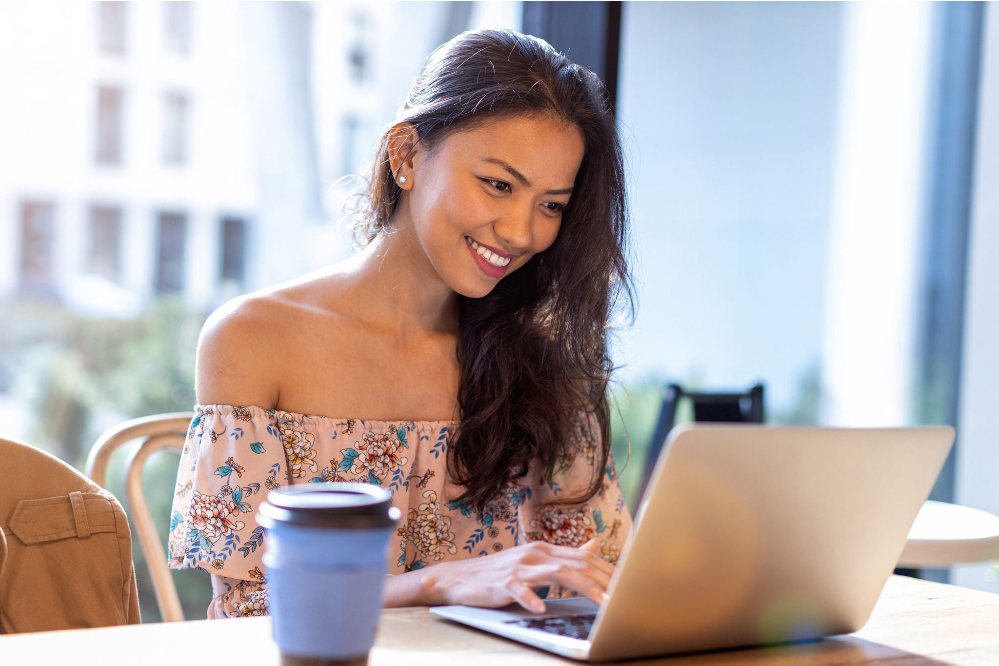 EY woman happily working from home