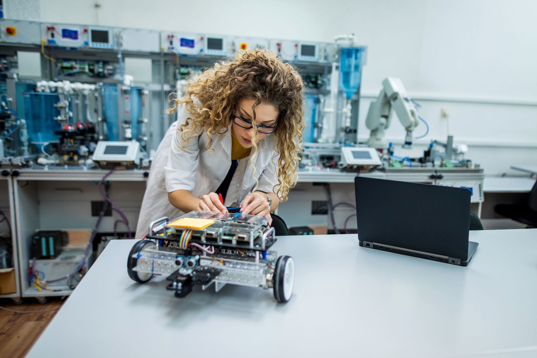 Young engineer analyzing new robot project