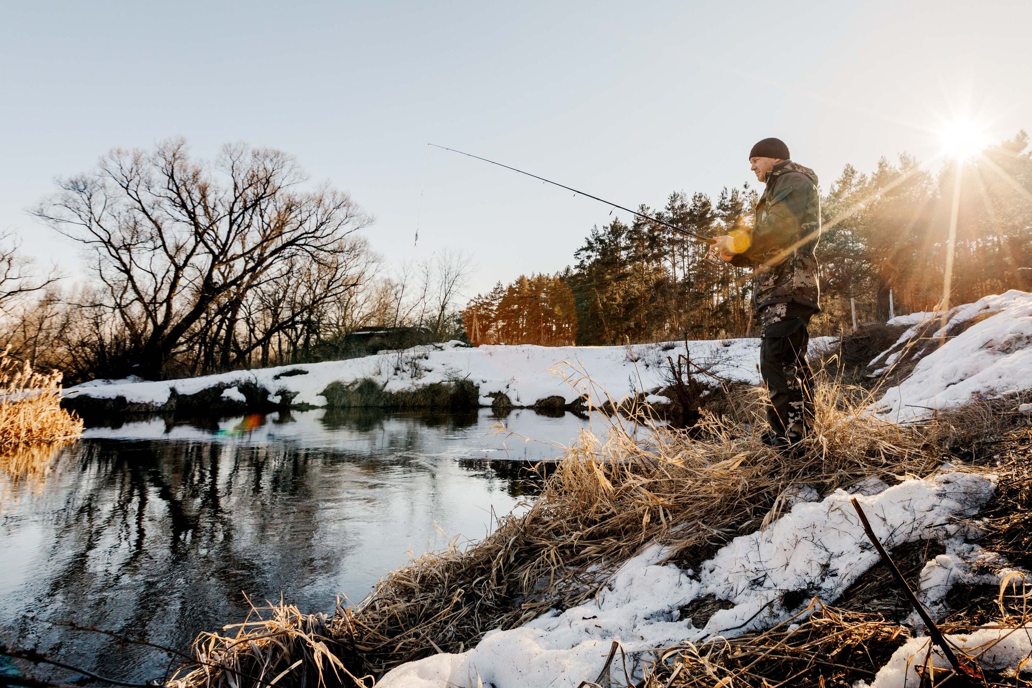 Warm patterned socks and a hot drink beside a fireplace