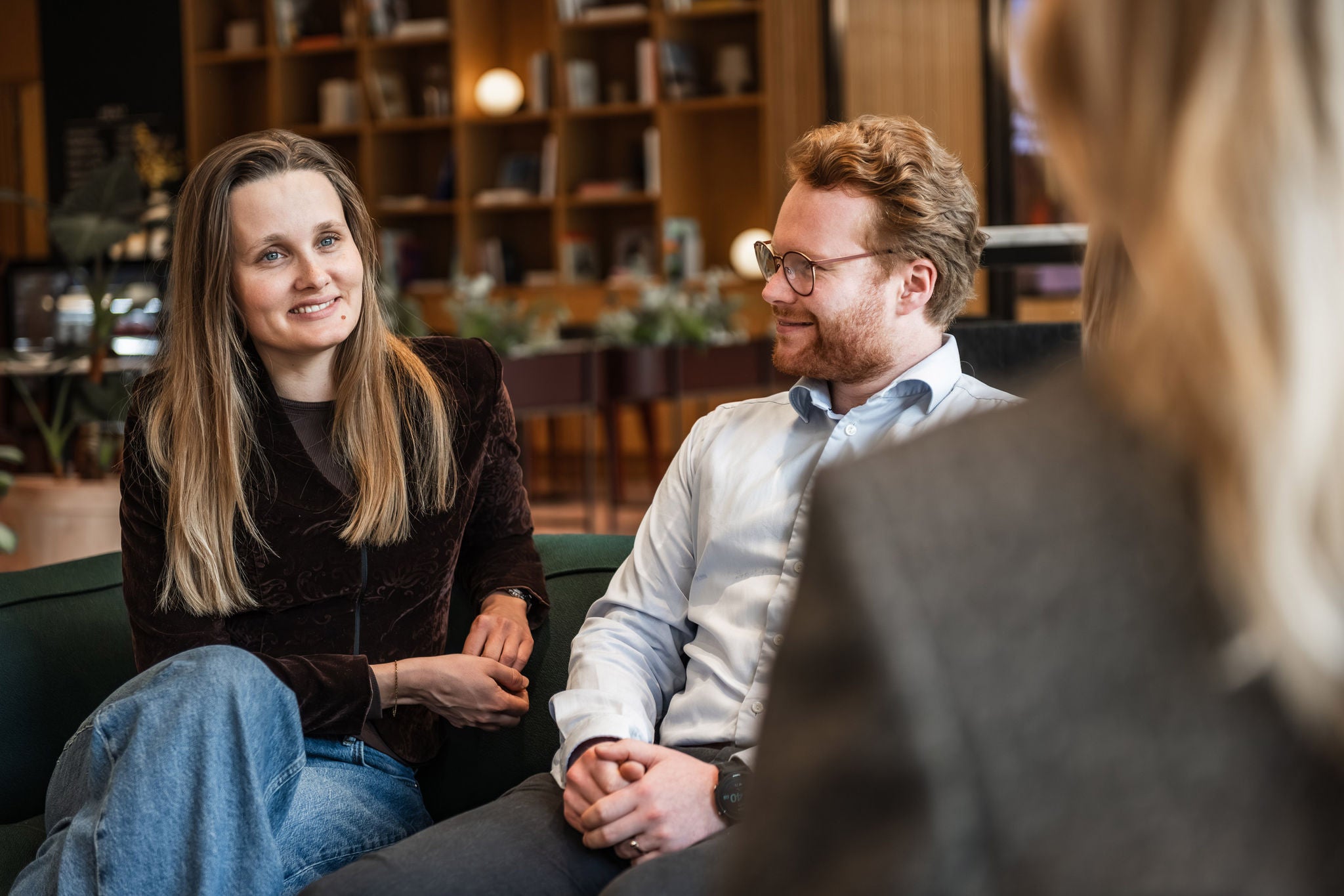 Professionals engaged in discussion in a modern workplace lounge