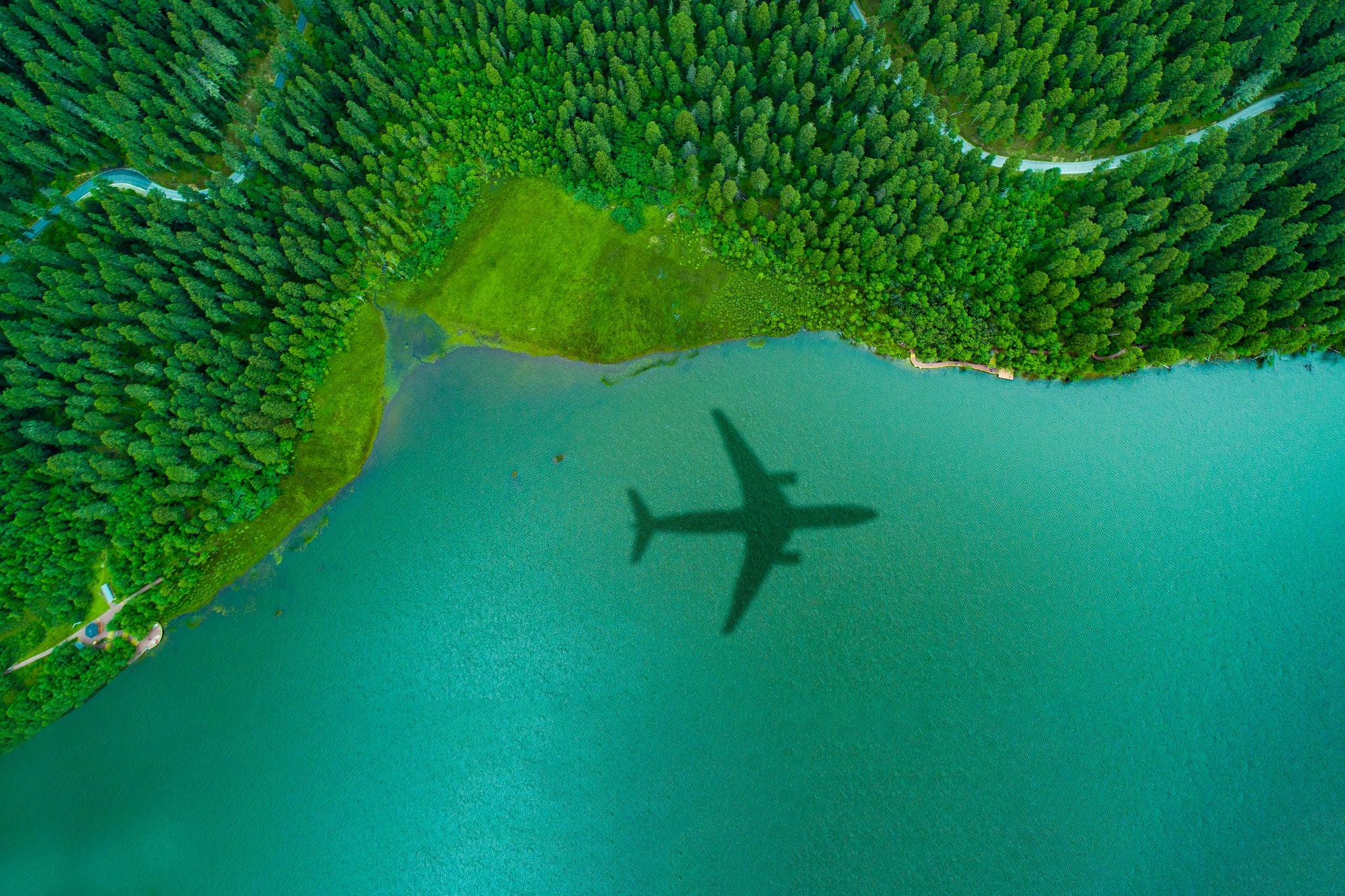 Airplane shadow over the island forest,green concept