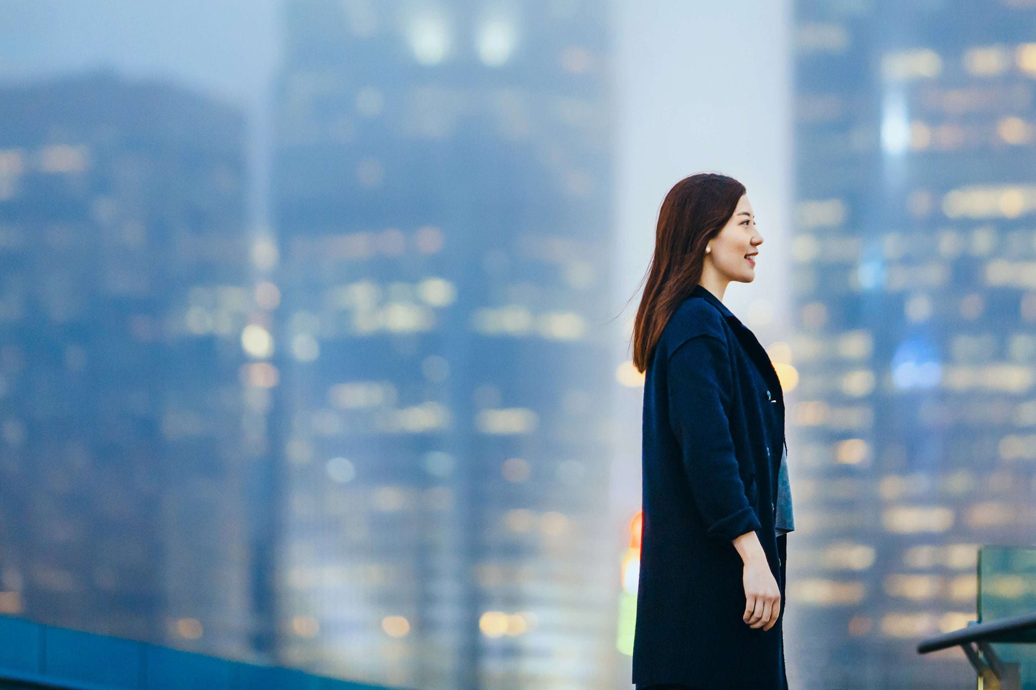 Image of a woman with a skyscrapers backdrop