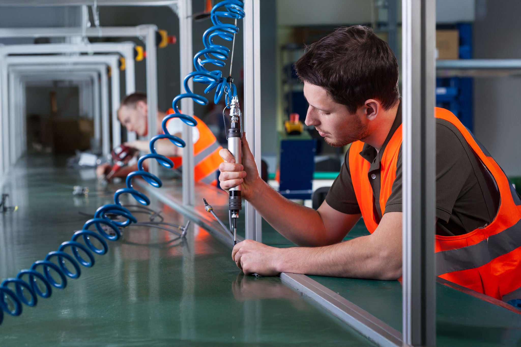 Horizontal view of factory workers and production process