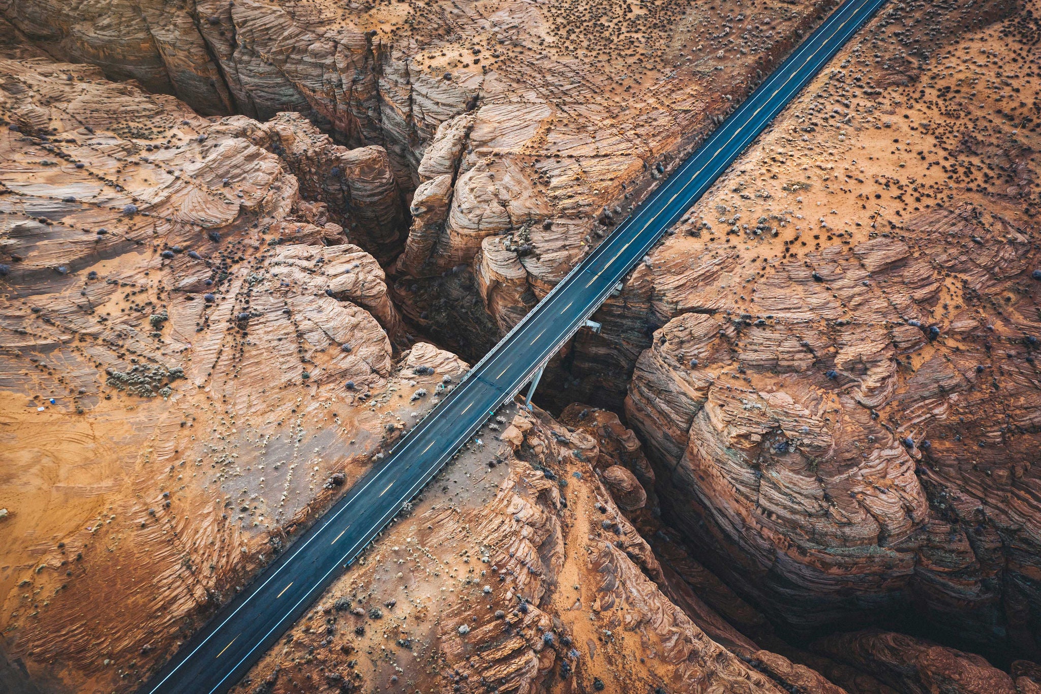 Highway running through a rocky desert canyon
