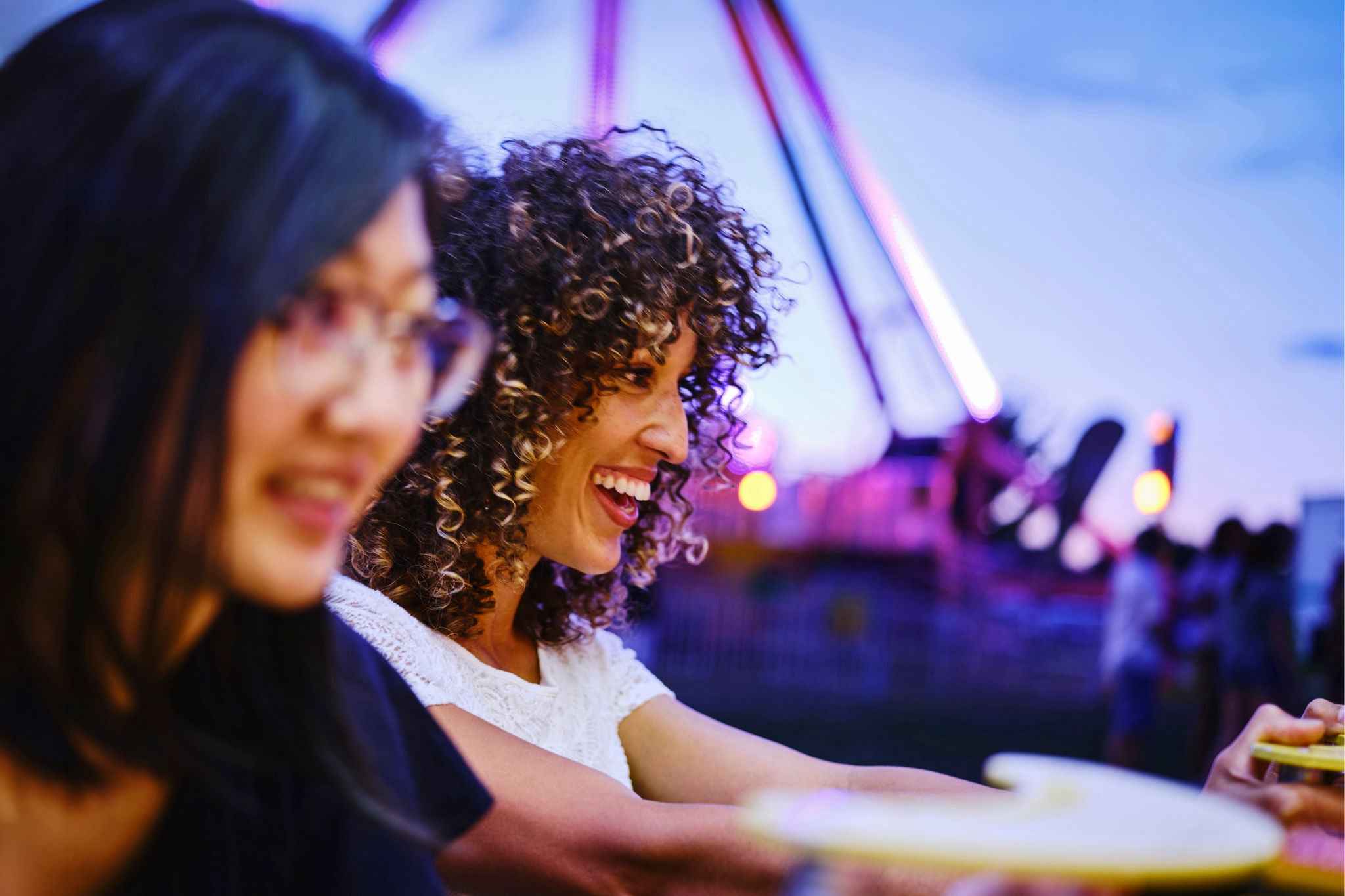 Friends having fun at summer carnival game