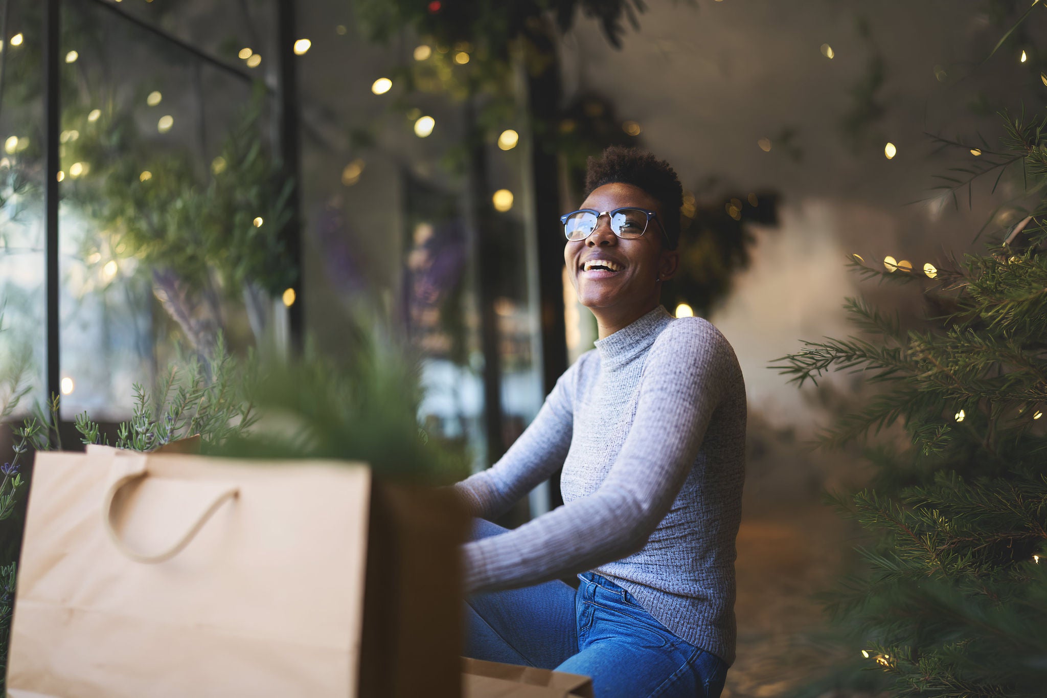 Cheerful american student in trendy eyewear enjoying having fun in coffee shop resting on break.