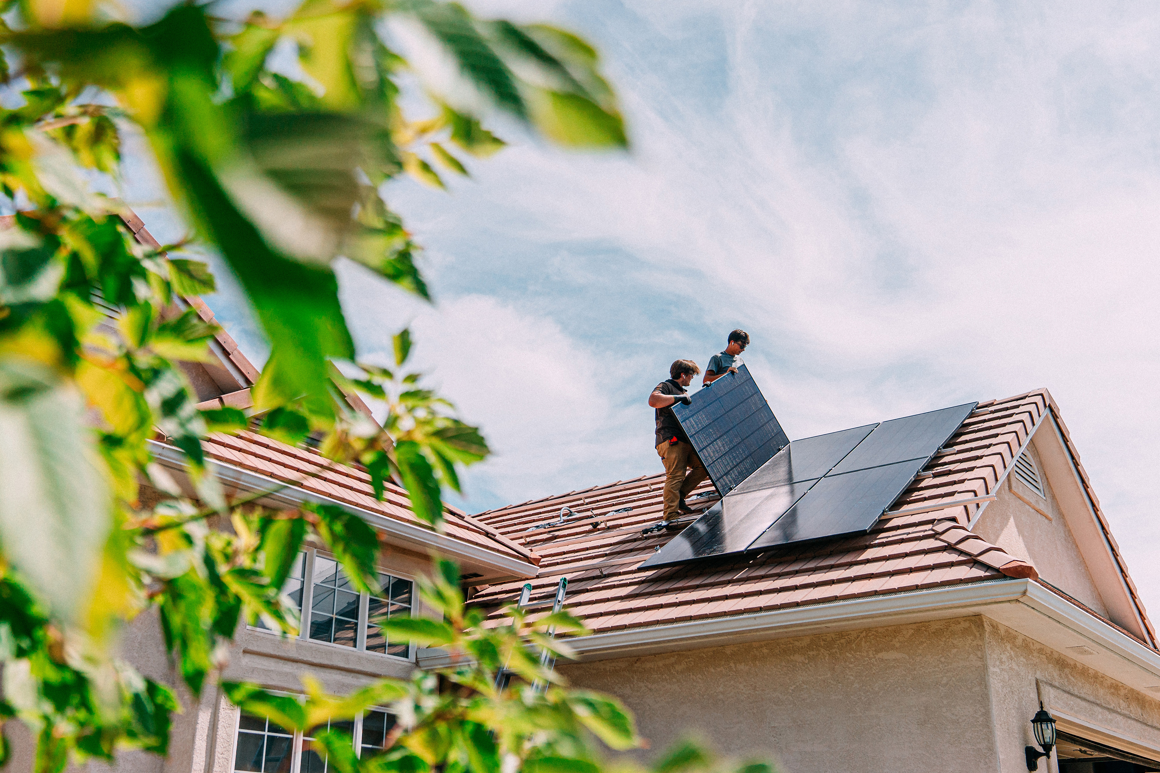 people-working-on-roof-installing-solar-panels
