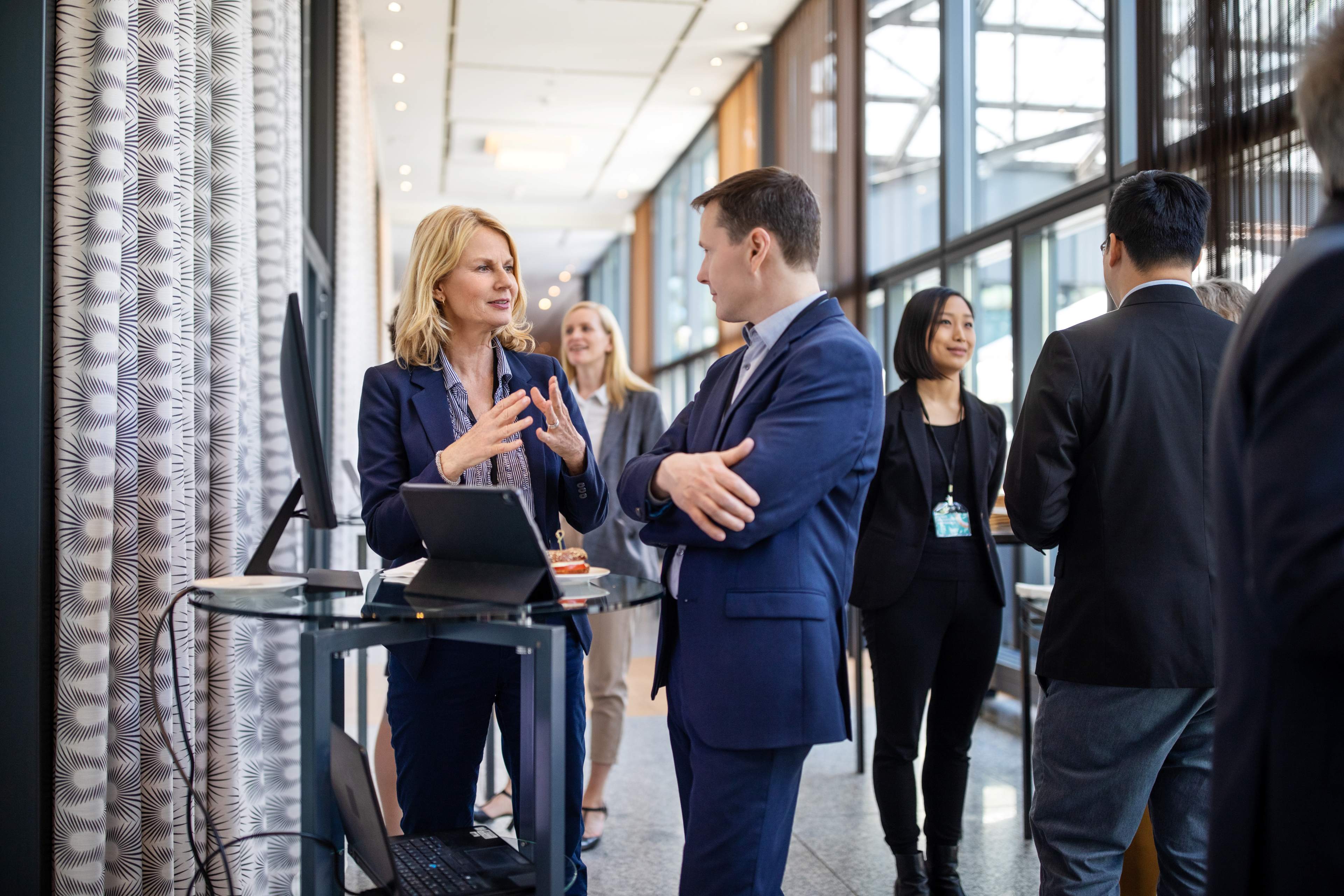 ey parthenon - ceo outlook survey - people in a conference lobby