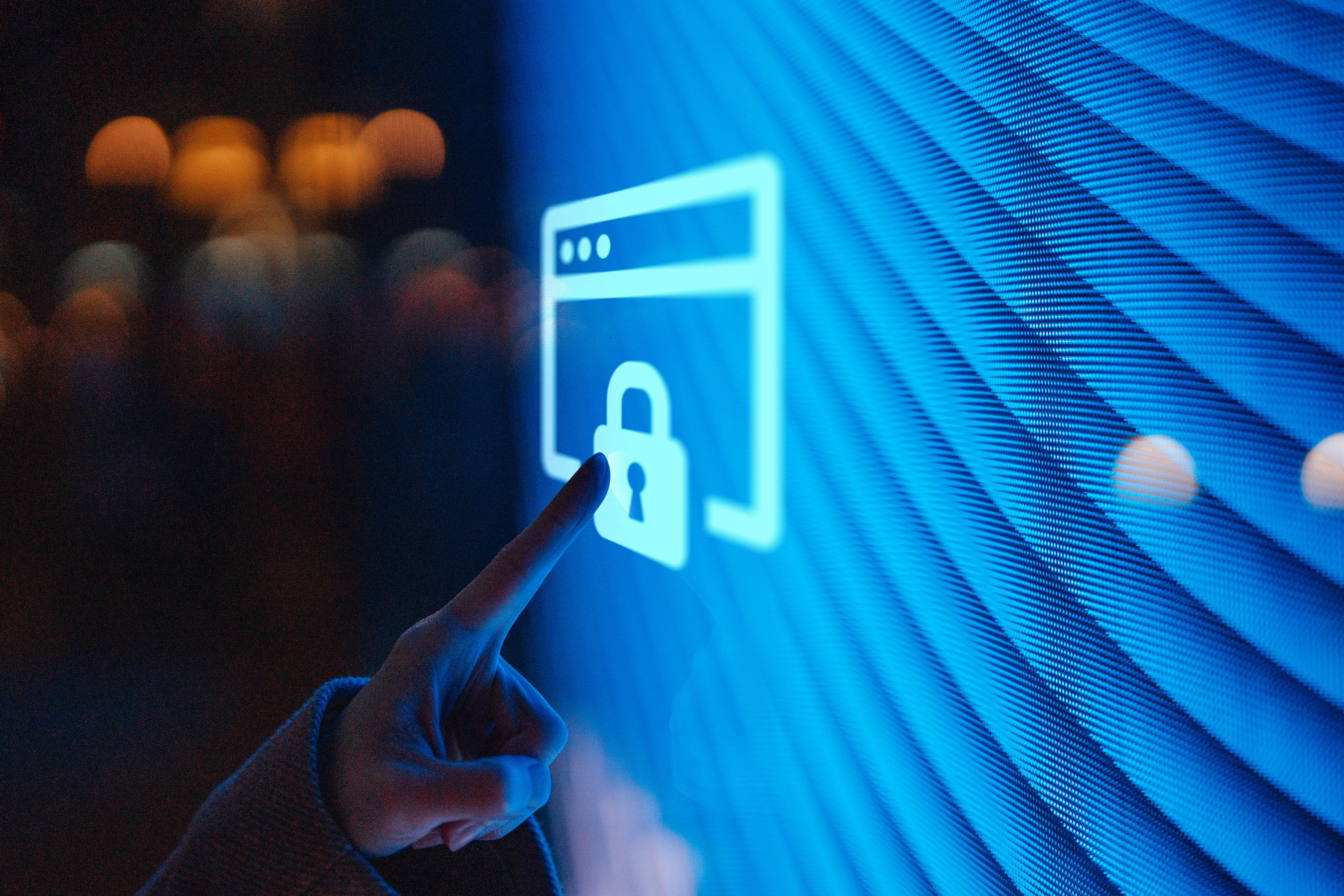 Hand touching a glowing digital screen with a lock icon