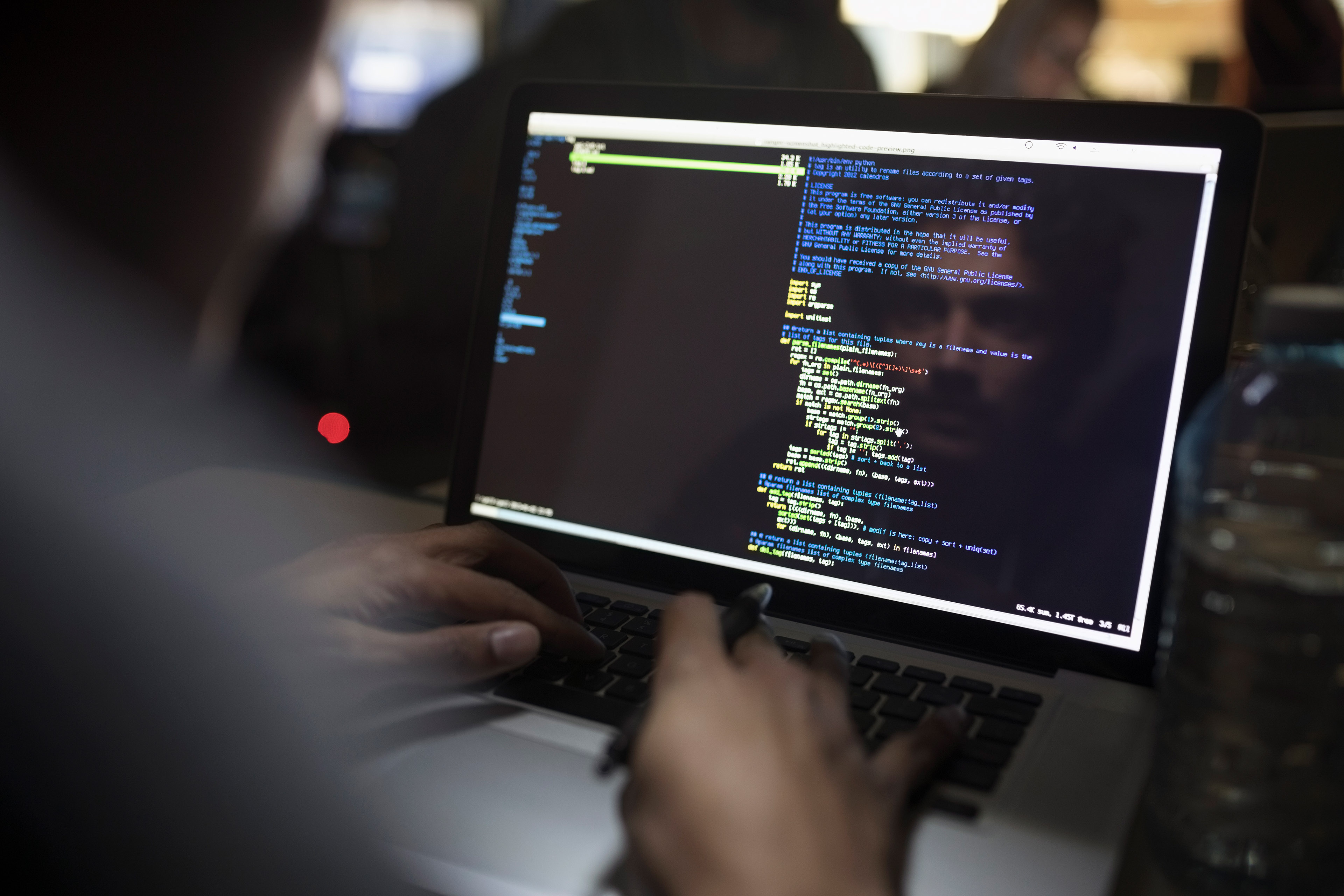 Man coding on laptop