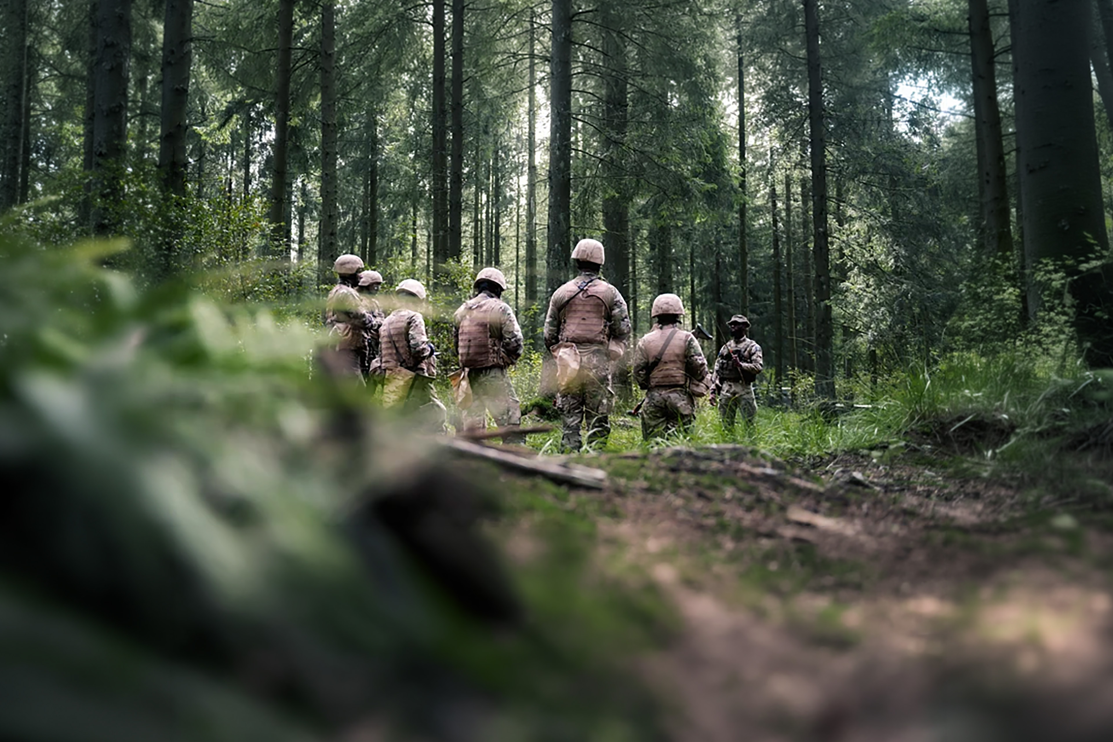 Group of soldiers walking through a forest