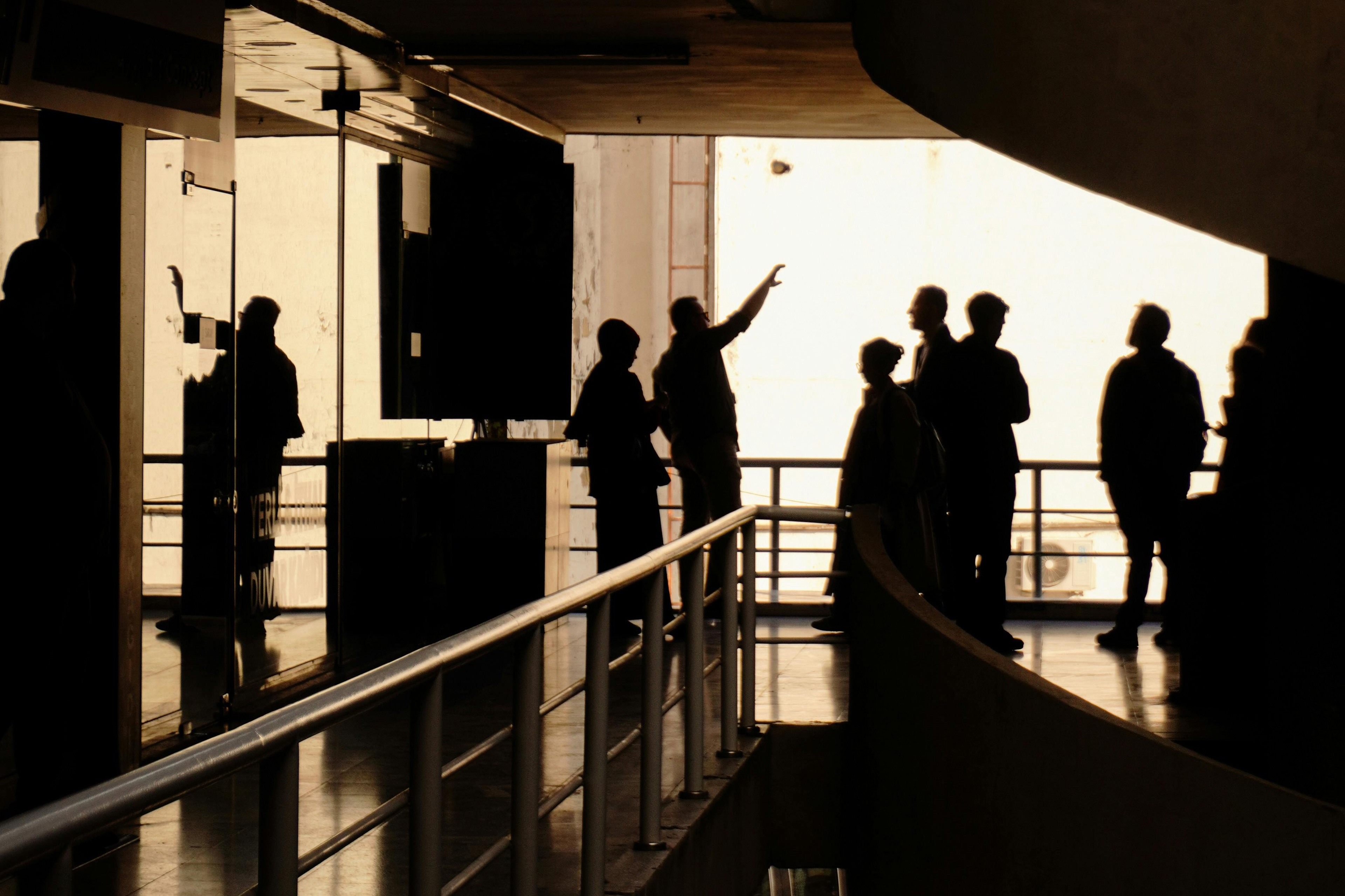 People sitting at a high table in an office with large windows and city view