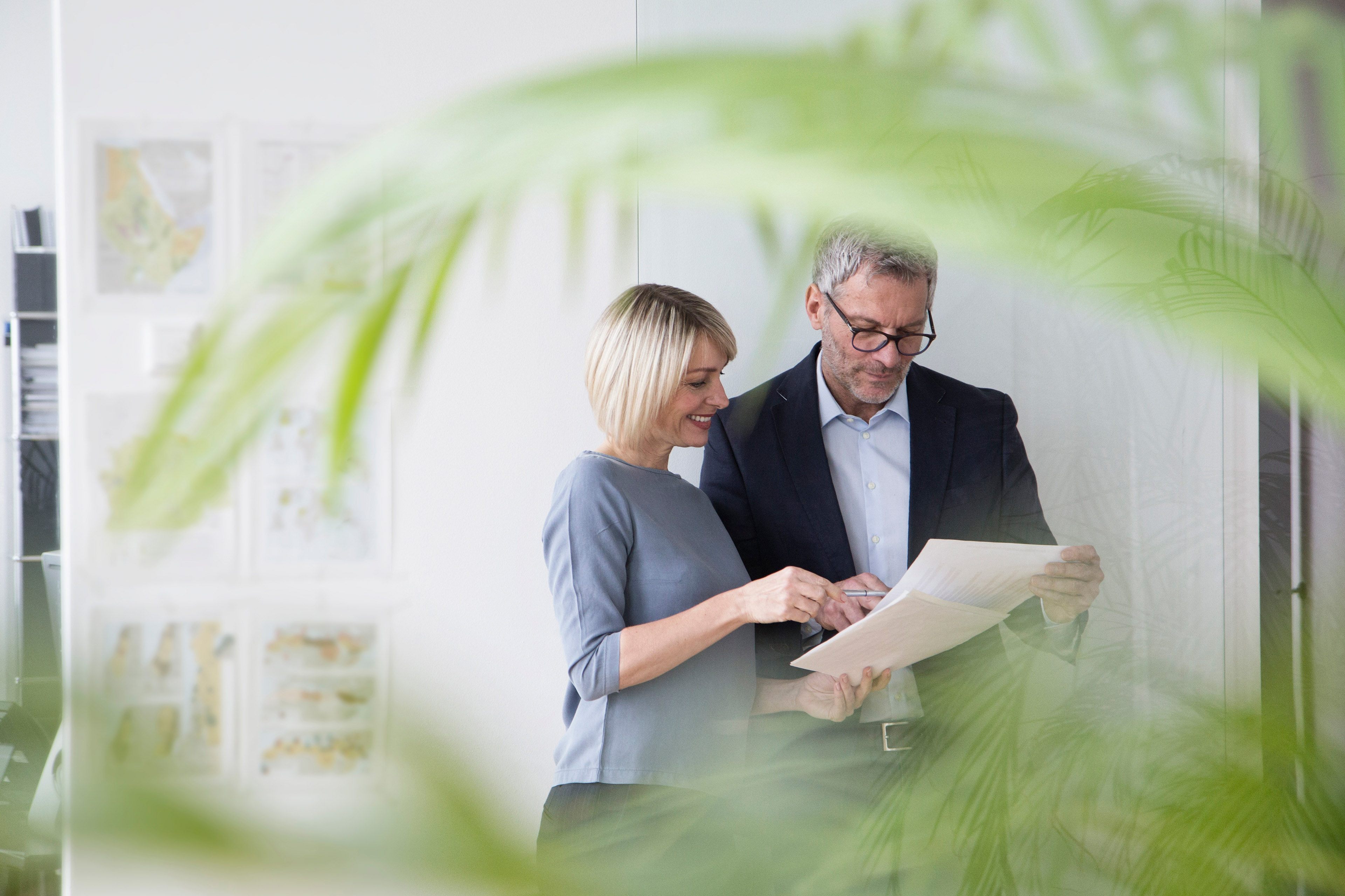 Two people looking at documents together in an office
