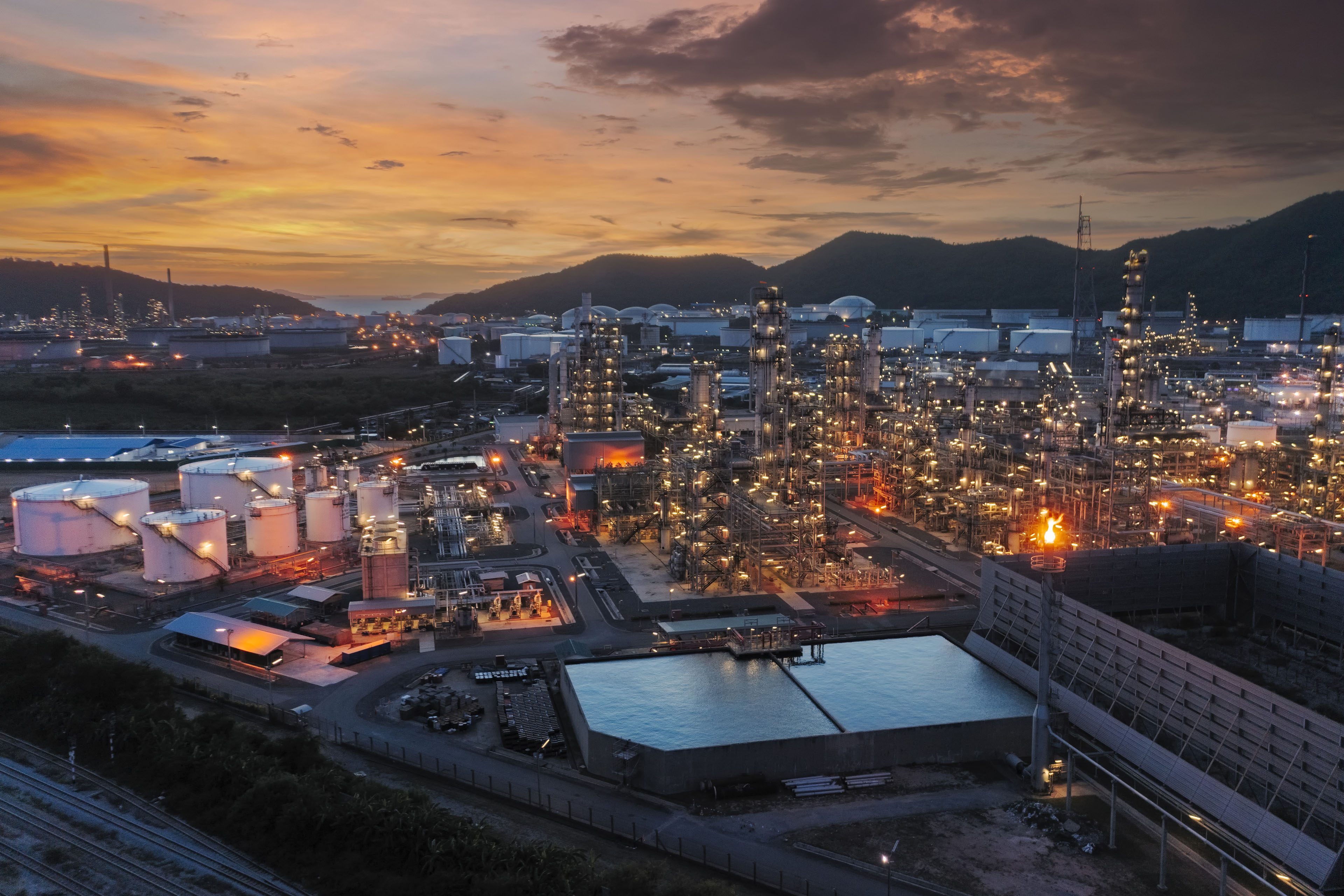 Two happy young businesspeople smiling while walking together in a hallway. 