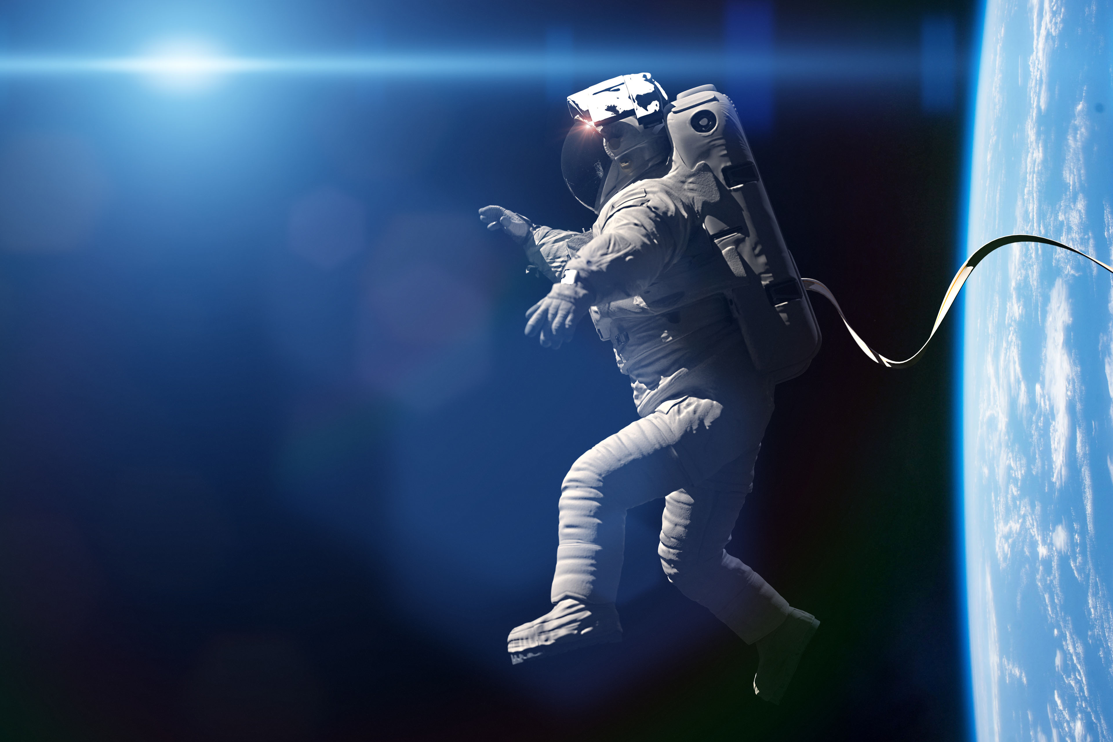 astronaut performing a spacewalk in orbit above Earth