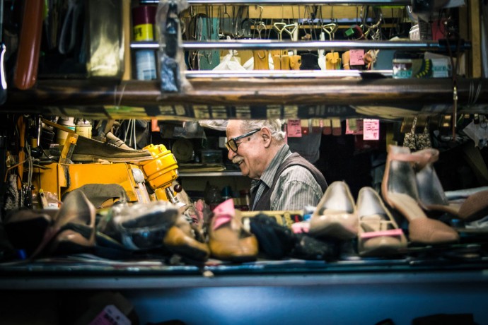 Senior man repairing his shoe