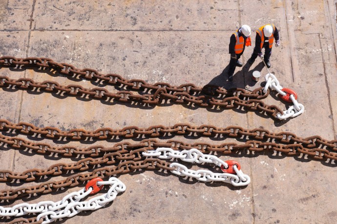 Workers anchor chain dry dock