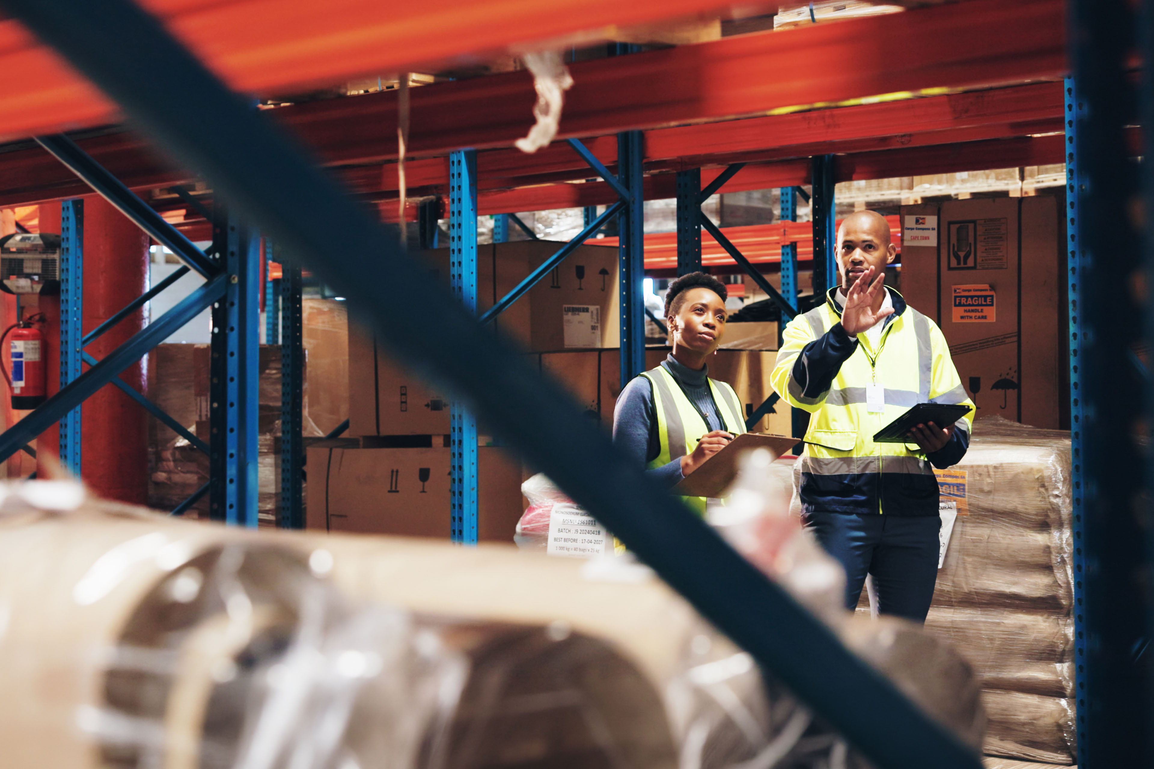 Business professionals using tablet to manage inventory