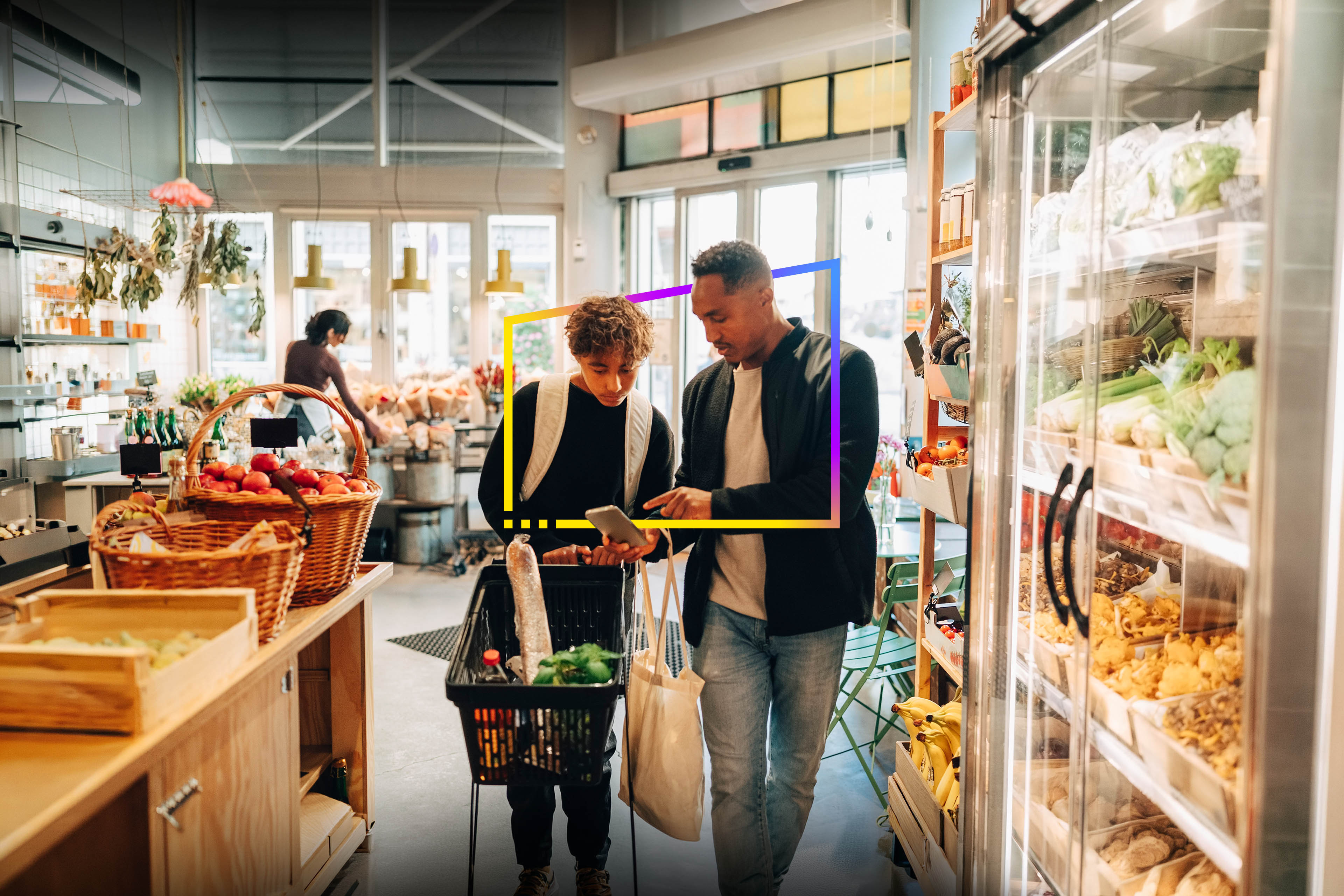 Father and son checking a shopping list on a smartphone while grocery shopping