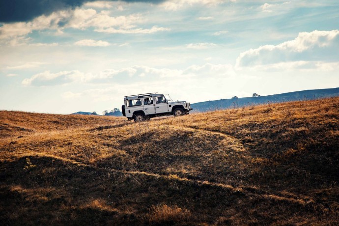 A photograph of a 4x4 car driving uphill