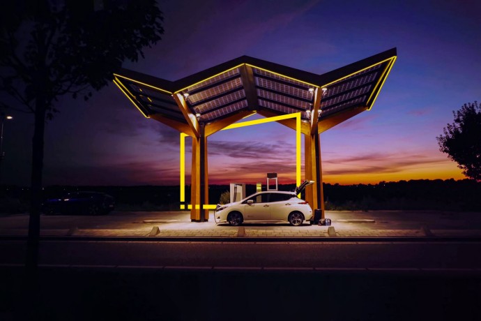 White Electric Car in a charging station at night metadata image