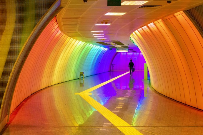 Man walking through a colorful subway