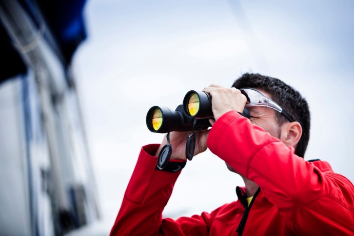 Sailor with binoculars in red jacket