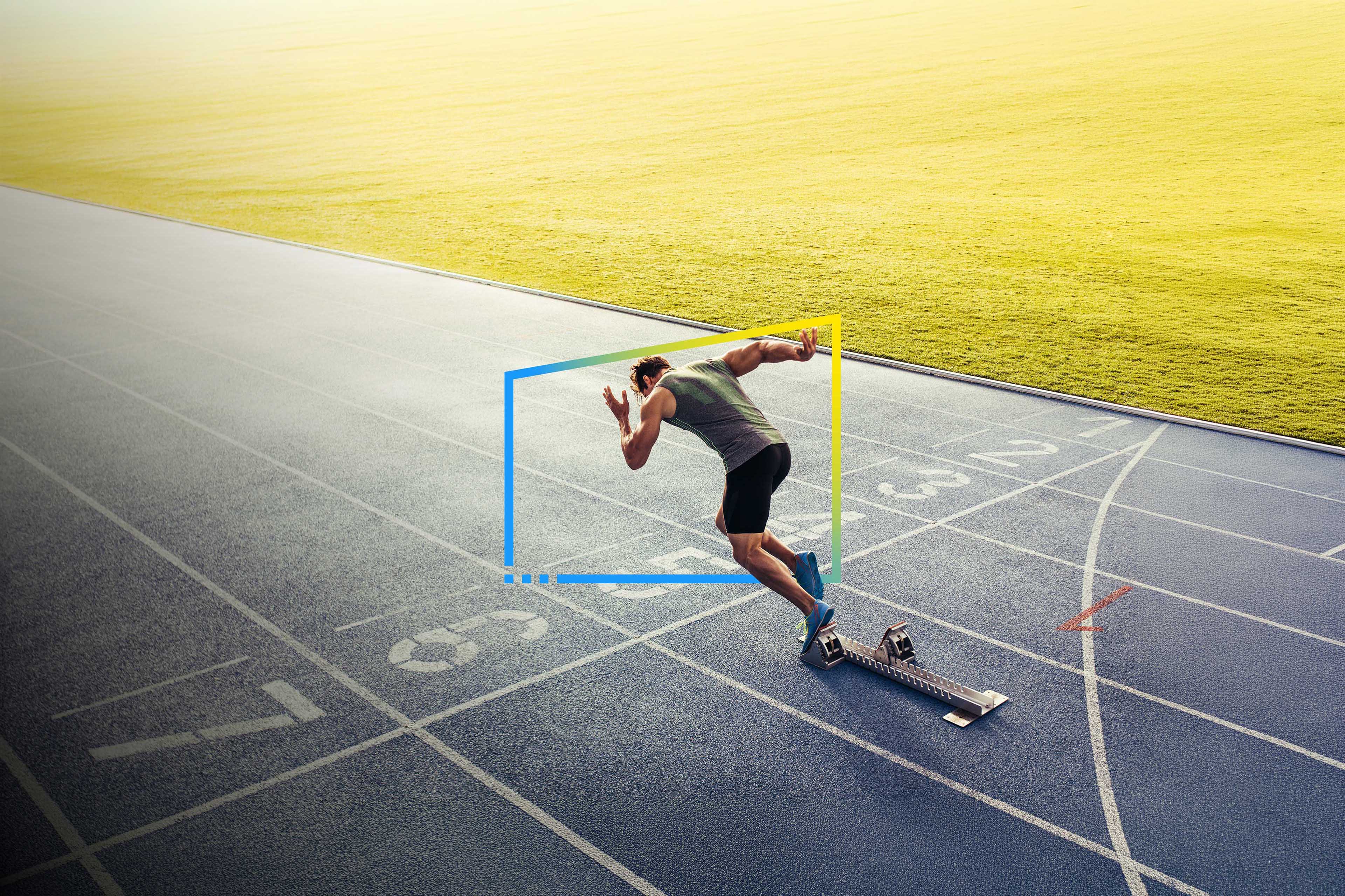 Runner starts sprint from blocks on track, representing speed, precision and forward momentum.