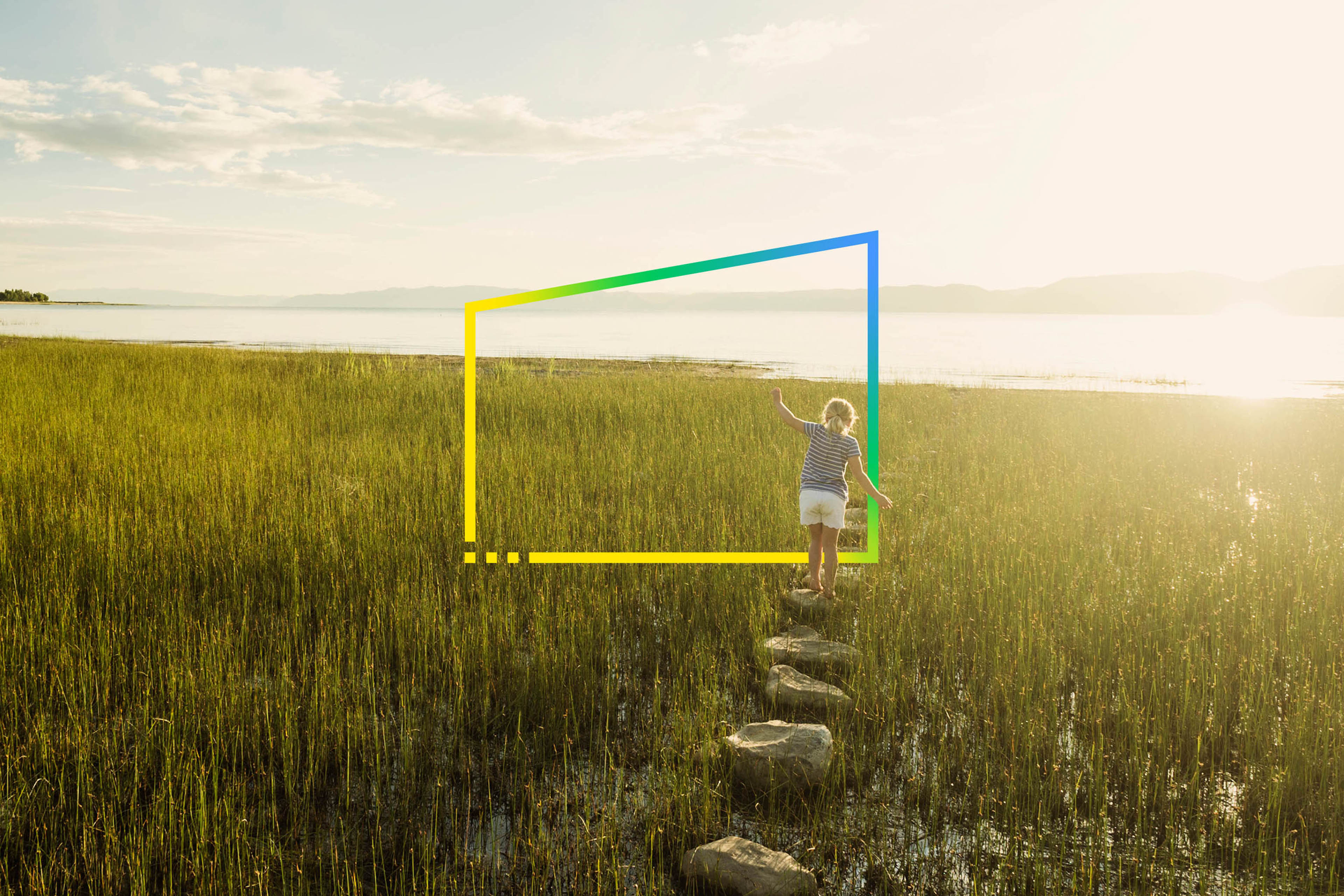 Little girl walking on stepping stones in meadow