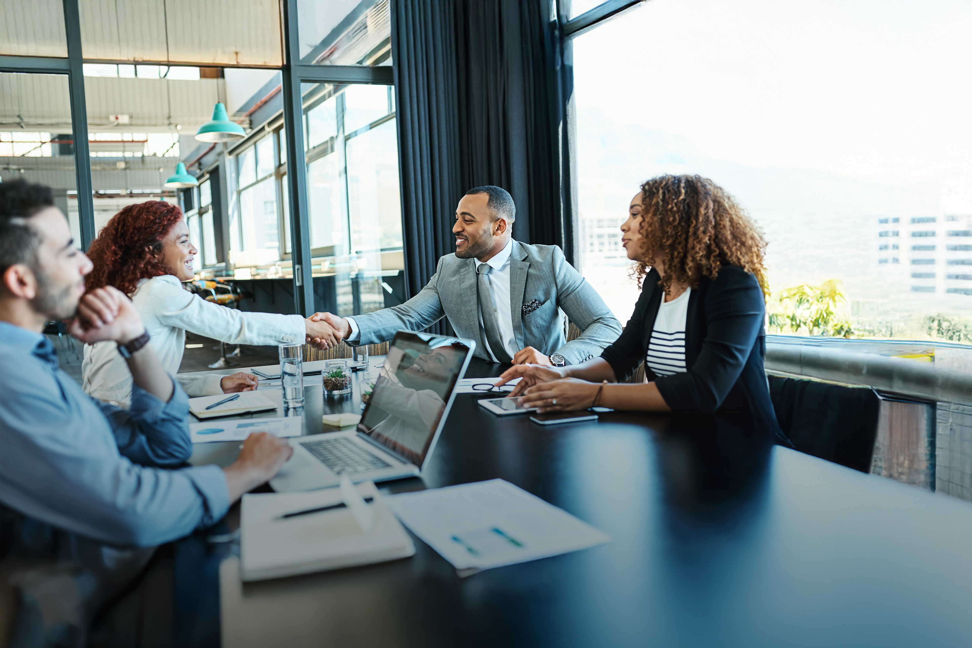 Businesspeople shaking hands during a meeting in an office