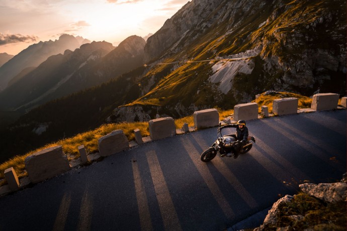 A man riding motorcycle on mountain road, Italy